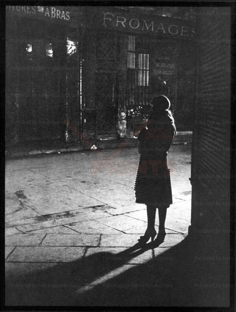 Brassai - Vintage Art, A woman standing in a Paris street at Night