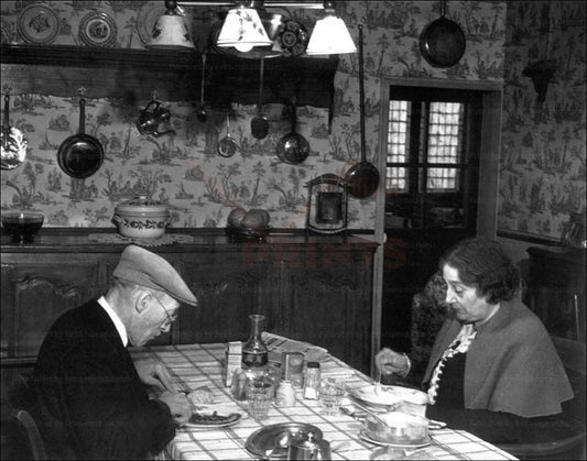 Elderly couple having dinner by Brassai