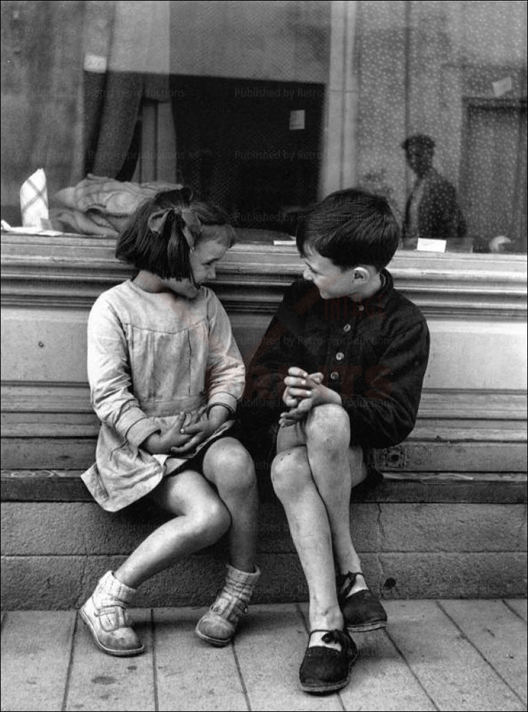 Young children  sitting on a Bench