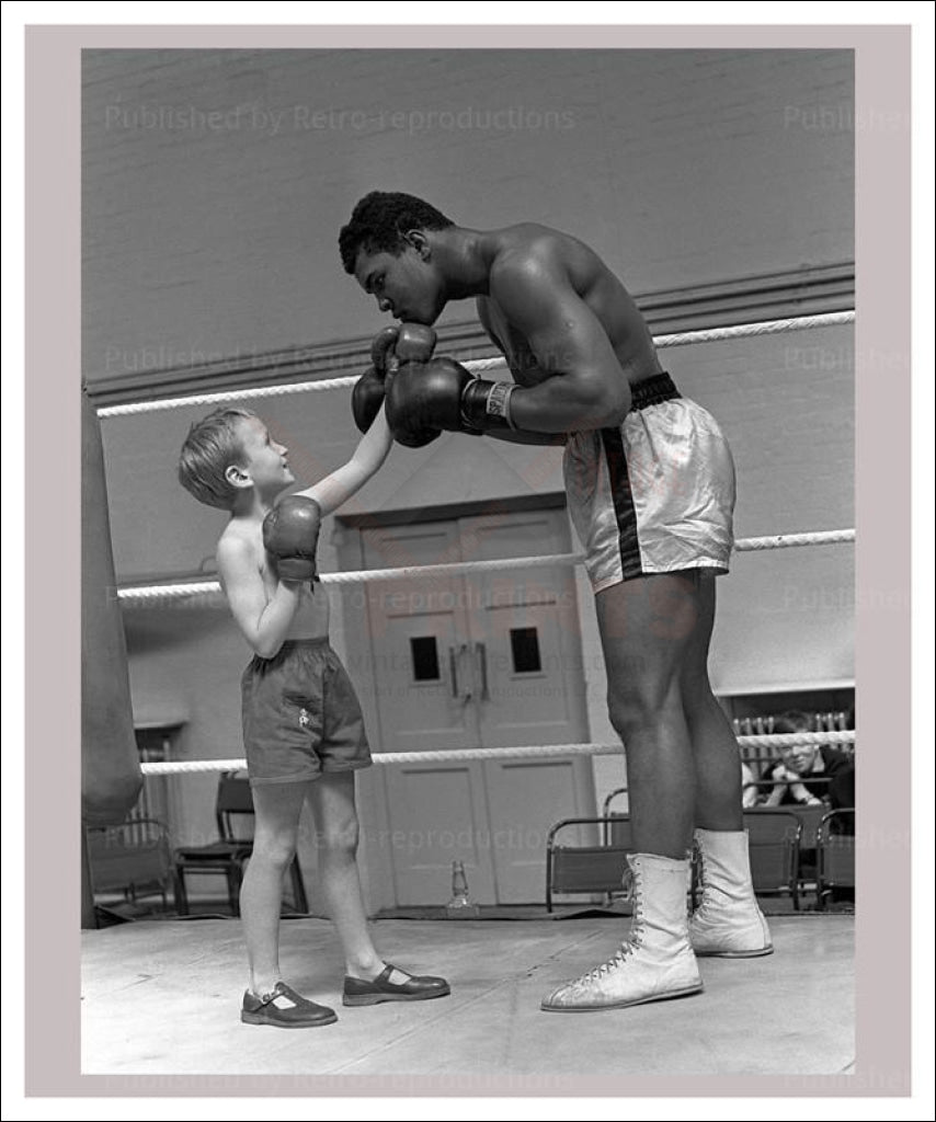Photo of boxer Muhammad Ali playfully sparring with young boy