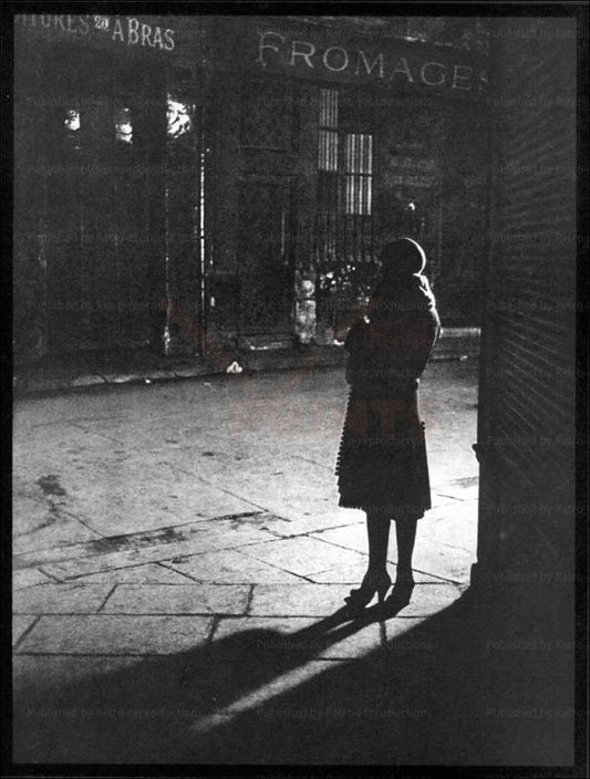 Brassai - Vintage Art, A woman standing in a Paris street at Night 